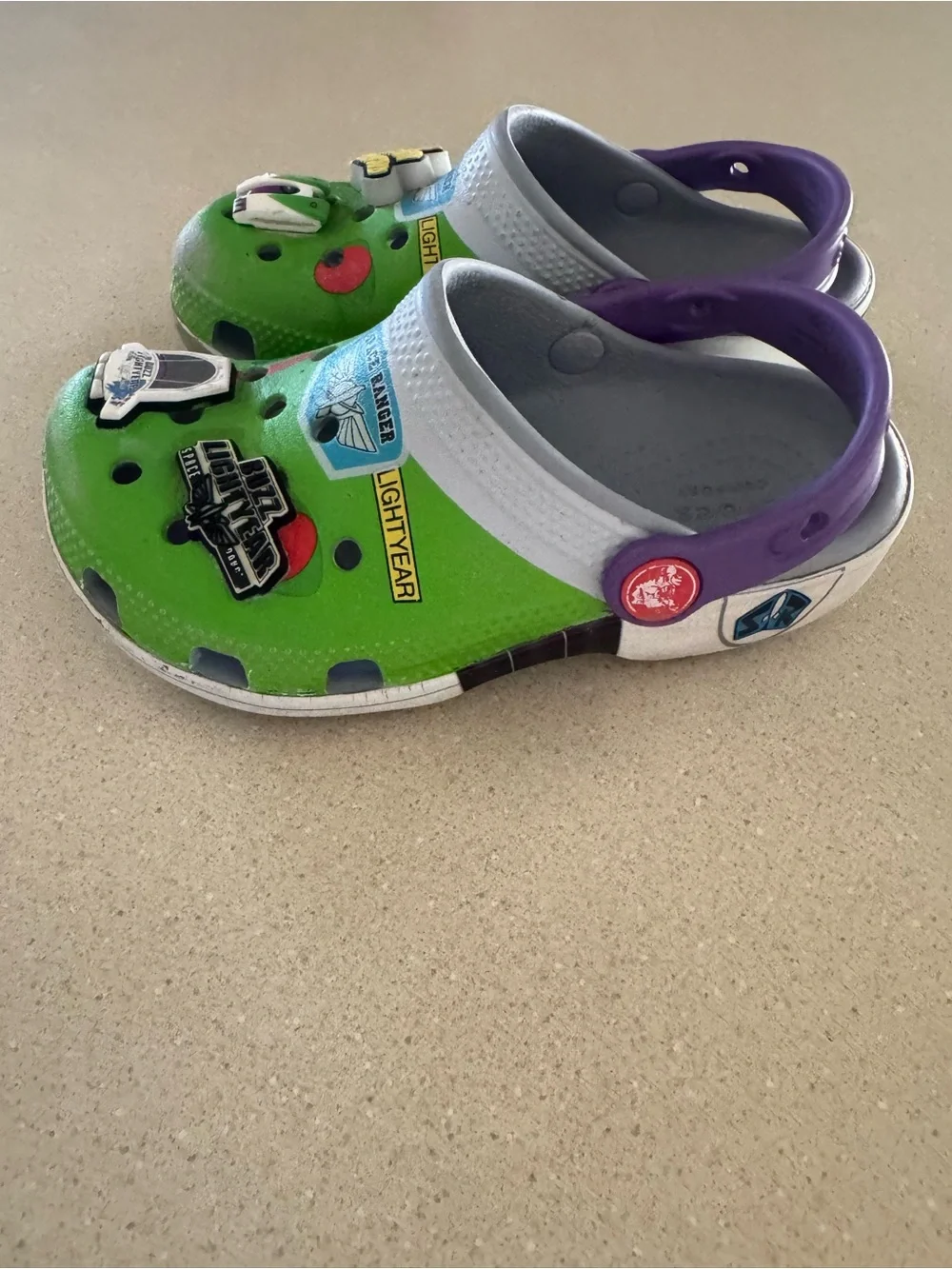 CROCS Kids Green Clogs with Purple Heel Strap and Space Charms